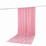 Pink draped fabric backdrop hanging on a rod, studio photo backdrop
