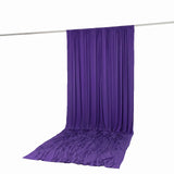 Purple draped fabric backdrop on a hanging rod, studio photography background