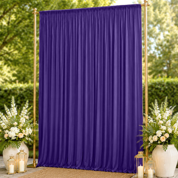 Purple draped wedding backdrop with gold frame and floral decor