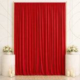 Elegant red curtain backdrop with white floral arrangements and candles