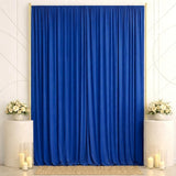 Elegant blue curtain backdrop with floral pedestals and candles