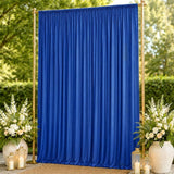 Blue wedding backdrop curtain with gold frame, floral arrangements and lanterns