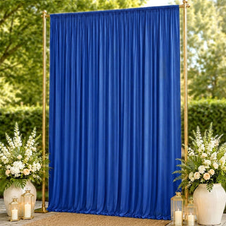 Blue wedding backdrop curtain with gold frame, floral arrangements and lanterns