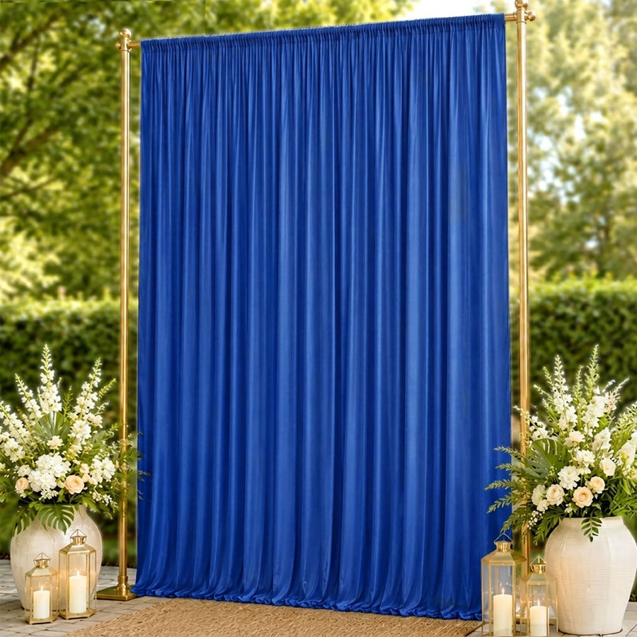 Blue wedding backdrop curtain with gold frame, floral arrangements and lanterns