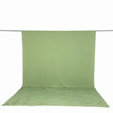 Light green fabric backdrop hanging on a studio backdrop stand