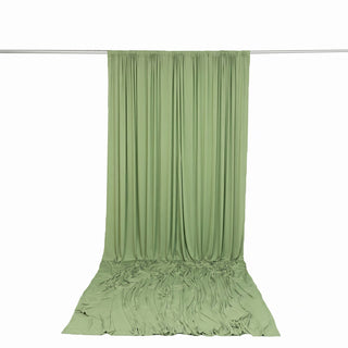 Light green draped fabric backdrop on a curtain rod
