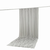 Light gray draped curtain on backdrop rod, studio background backdrop