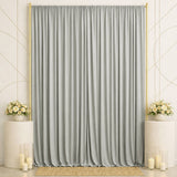 Elegant silver draped backdrop with gold frame, floral arrangements, and candles