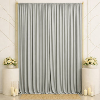 Elegant silver draped backdrop with gold frame, floral arrangements, and candles