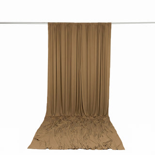 Tan draped fabric backdrop curtain on a white background