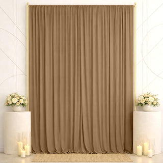 Elegant beige curtain backdrop with floral arrangements and candles