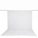 White sheer fabric backdrop draped on a horizontal rod on a white background