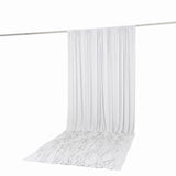 White sheer curtain draped over a silver rod on a white background