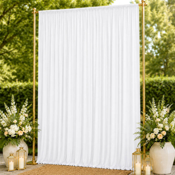 Gold frame white draped wedding backdrop with floral arrangements and lanterns