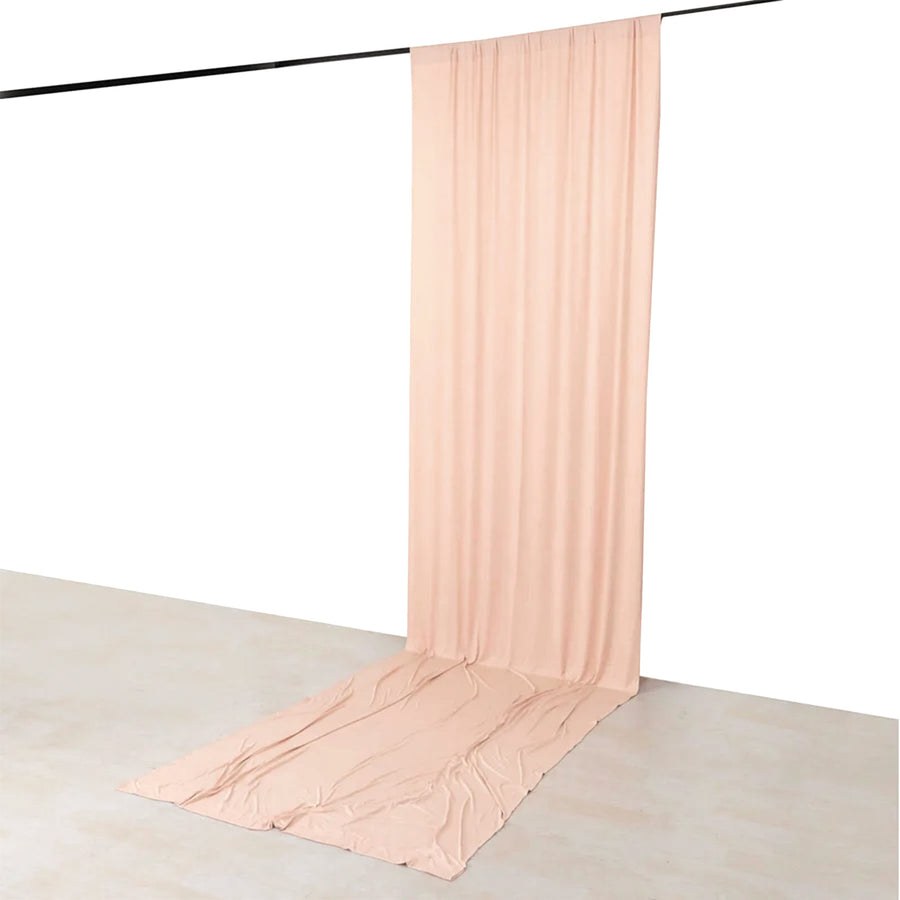 Blush pink sheer backdrop curtain with floor drape on a black rod