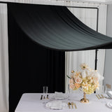 Elegant floral centerpiece with gold accents on a dining table setting.