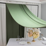 Elegant table setting with green drapery and floral centerpiece.