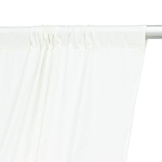 White curtain draped on a rod, showcasing soft fabric texture.