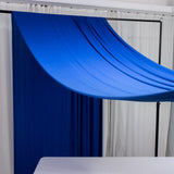 Blue fabric draped over a frame in a studio setting.