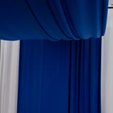 Blue fabric draped elegantly, creating a soft, textured background.