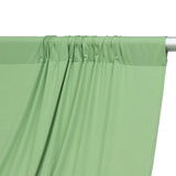 Green curtain fabric draped elegantly on a rod.