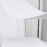 Studio backdrop with draped white fabric and a clean, minimal setup.