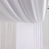 White draped fabric creating a soft, elegant backdrop.
