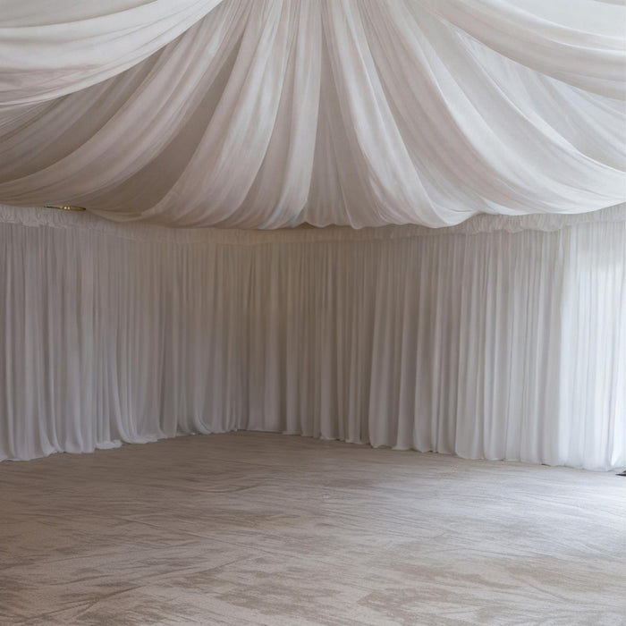 Elegant white draped fabric ceiling in a spacious indoor setting.