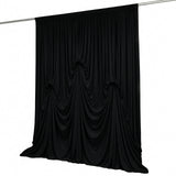 Black draped curtain backdrop on hanging rod, elegant event decor