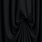 Black draped fabric with dramatic gathered folds on dark background#whtbkgd