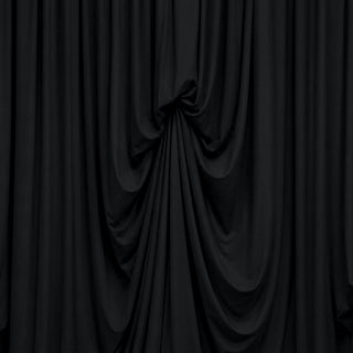 Black draped fabric curtain with elegant folds and shadows