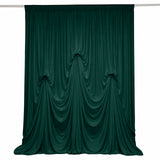 Dark green velvet curtain with elegant draped folds on a white background