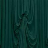 Abstract dark green draped fabric with flowing folds and texture
