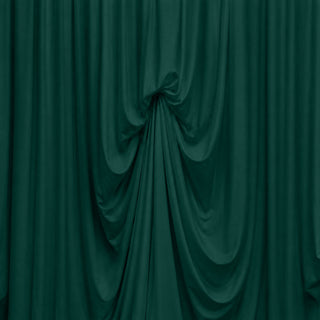 Abstract dark green draped fabric with flowing folds and texture