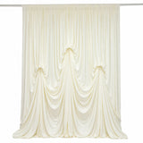 Cream pleated draped curtain panel on rod, elegant fabric backdrop
