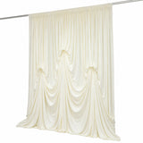 Cream draped curtain panel on rod, elegant sheer fabric backdrop