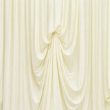 Cream draped fabric backdrop with elegant gathered folds