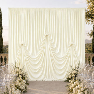 Elegant ivory wedding backdrop with draped curtain and floral aisle decor