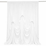 Elegant white draped curtain backdrop with soft flowing fabric folds