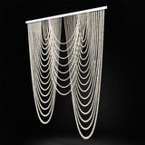 Elegant beaded curtain drapes in cascading layers on a dark background.