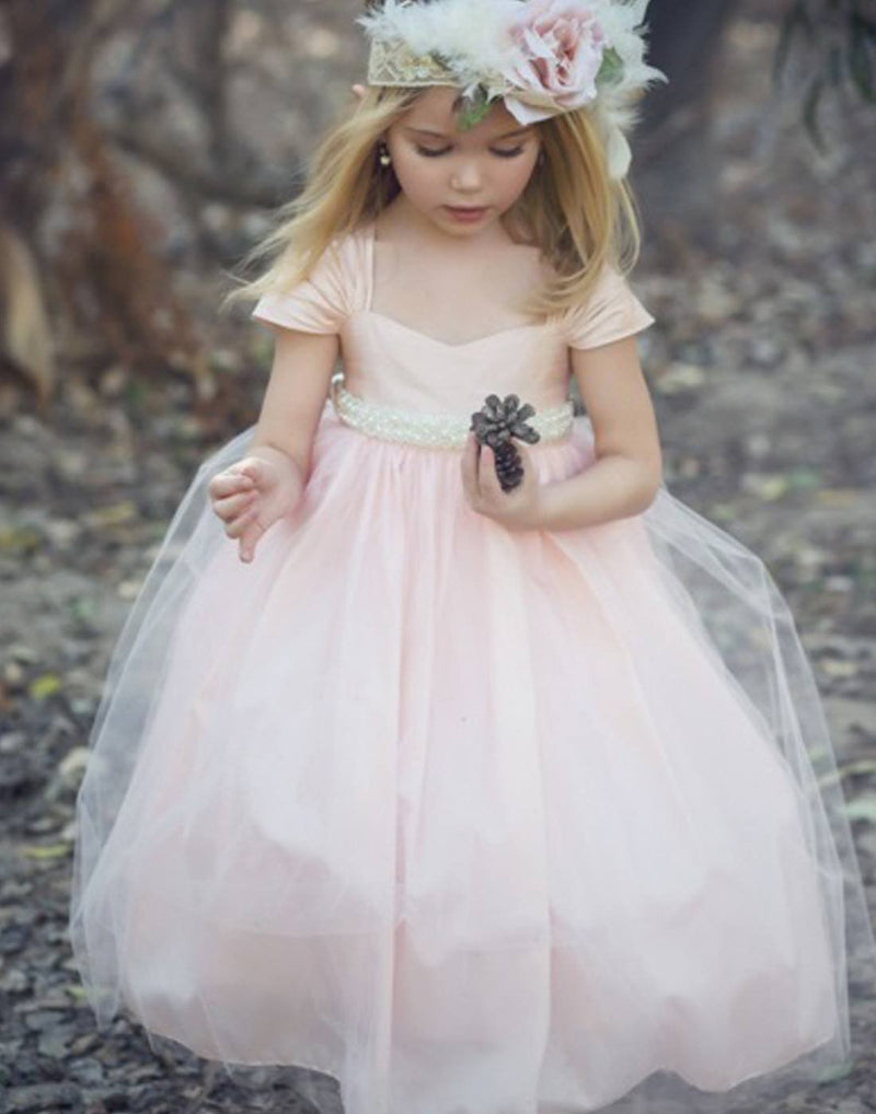 girl in a white floral dress on a bench