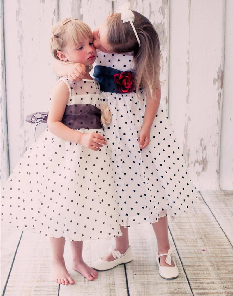 two toddlers in pastel dresses with flower baskets