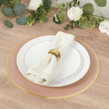 Elegant dinner setting with plate, napkin, and gold accents on wooden table.