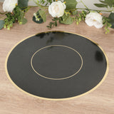Black and gold circular placemat on a wooden surface with floral decor.