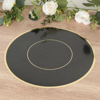 Black and gold circular placemat on a wooden surface with floral decor.