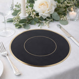 Elegant black placemat with gold accents on a beautifully set dining table.