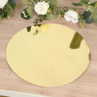 Gold oval mirror tray on a wooden surface with floral accents.