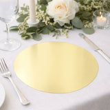 Gold round placemat on a beautifully set dining table with floral accents.