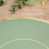 Green plate with gold rim on textured surface with greenery accents.