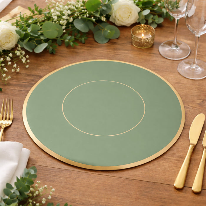 Green placemat with gold trim on a wooden table, surrounded by greenery and candles.